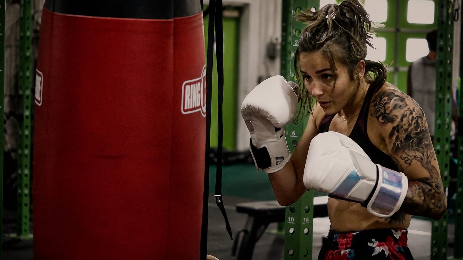 Cerus Fitness member throwing a punch on a heavy bag during a coached boxing session