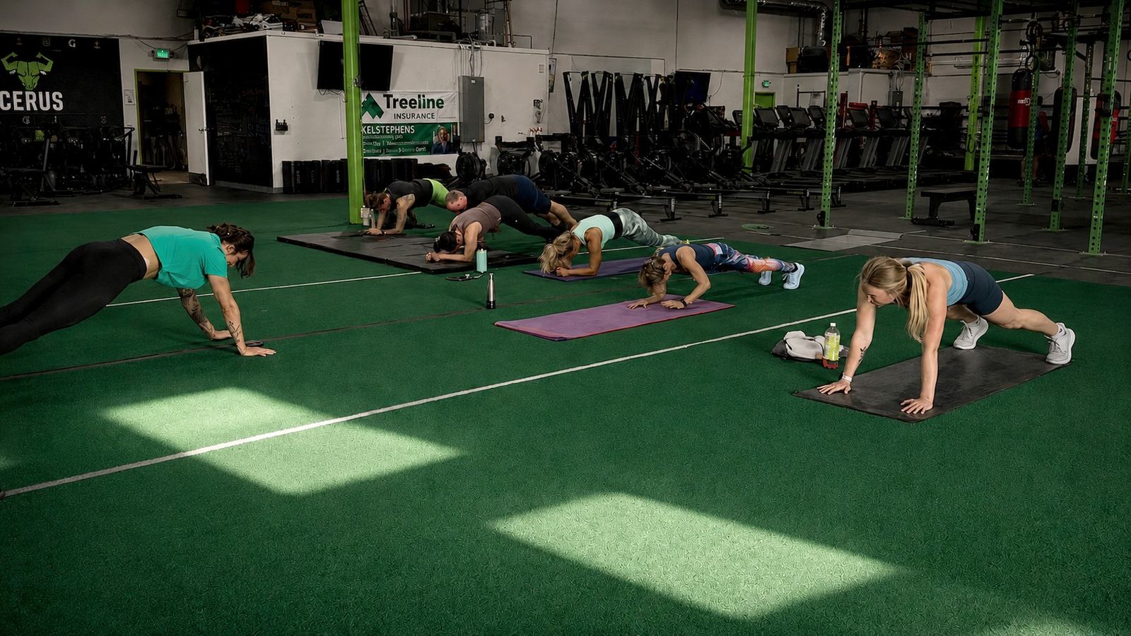 Cerus Fitness members holding plank position during a coached Core30 class